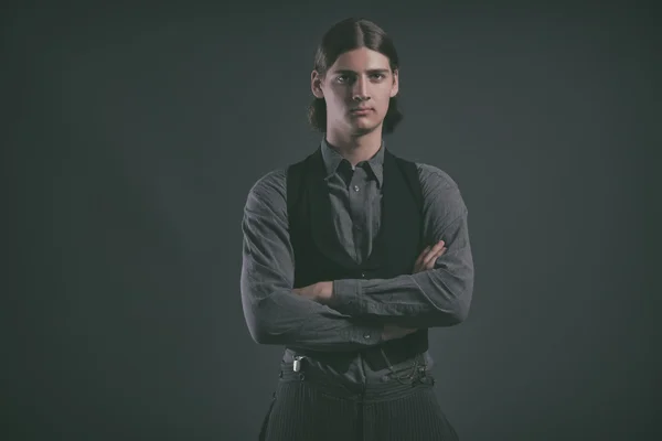 Western 1900 fashion man with brown hair. Studio shot against gr — Stock Photo, Image