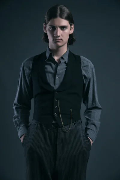 Western 1900 fashion man with brown hair. Studio shot against gr — Stock Photo, Image