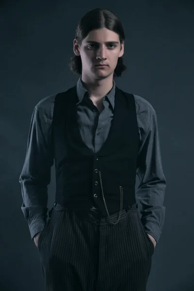 Western 1900 fashion man with brown hair. Studio shot against gr — Stock Photo, Image