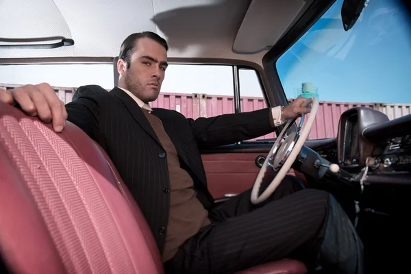 Retro 60s fashion business man wearing grey suit with tie sittin — Stock Photo, Image