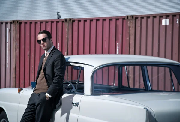 Retro 60s fashion business man wearing grey suit and black sungl — Stock Photo, Image