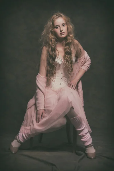 Vintage fashion woman wearing pink cardigan with dress. Sitting — Stock Photo, Image