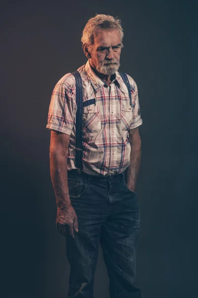 Characteristic senior man with gray hair and beard wearing check — Stock Photo, Image