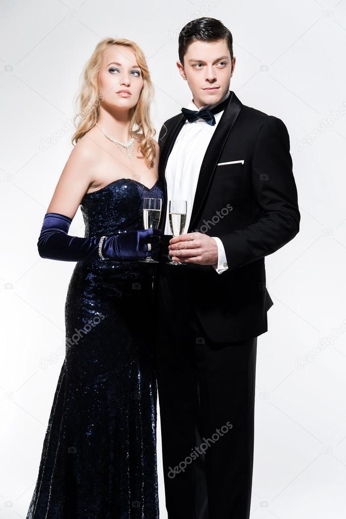 Romantic new year's eve fashion couple toasting with champagne. 