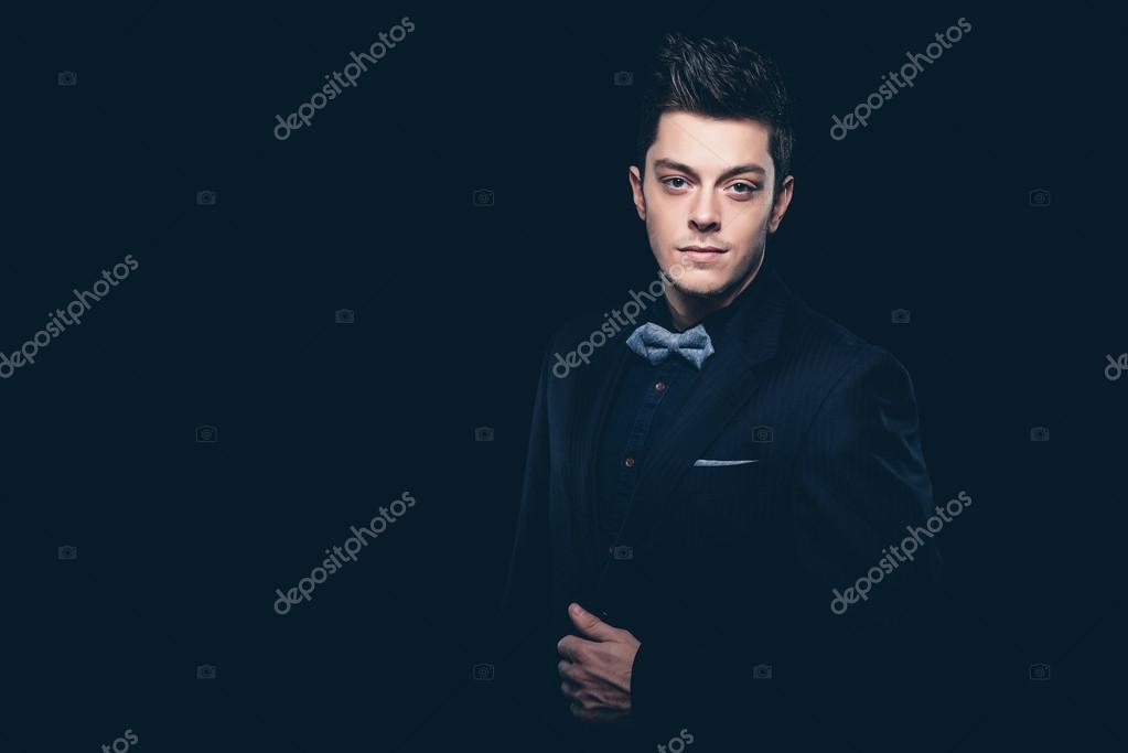 Retro Fashion Man With Blue Shirt Jacket Jeans And Bow Tie