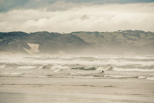 海景与健美运动员在海浪之间游动。金察海滩. — 图库照片