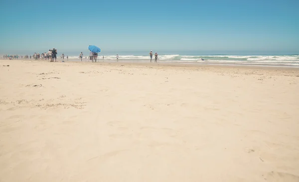 Dichter sonniger Strand mit blauem Sonnenschirm und klarem Himmel. Morganbucht — Stockfoto