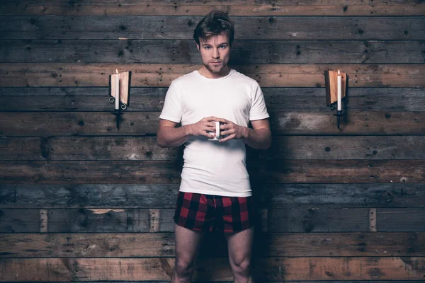 Man with blonde hair wearing white t-shirt and red flannel short — Stock Photo, Image