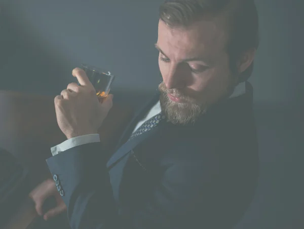 Bearded man enjoying a brandy — Stock Photo, Image