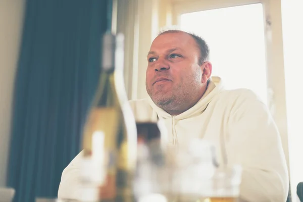 Middle-aged man sitting thinking — Stock Photo, Image