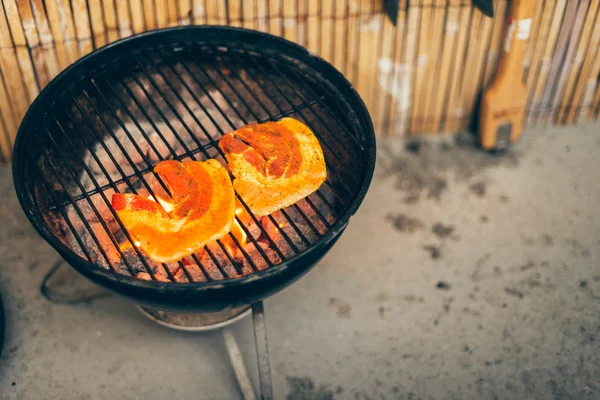 Wedges of fresh pumpkin grilling on a BBQ — Stock Photo, Image