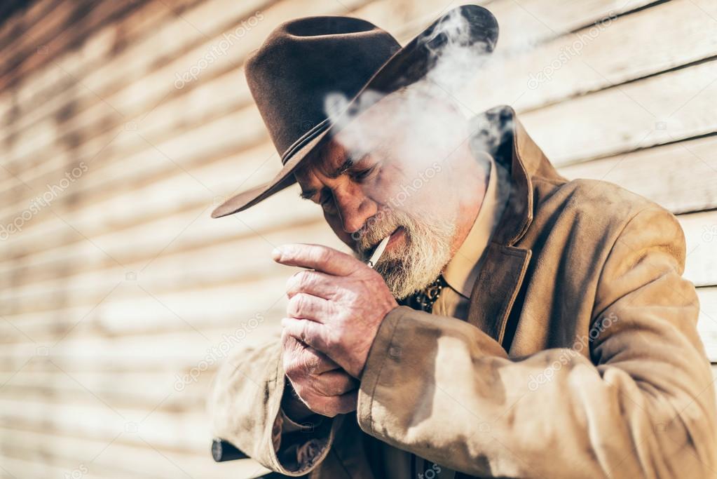 Senior man lighting up his cigarette