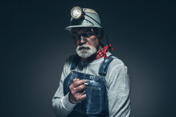 Reflective Senior Male Miner