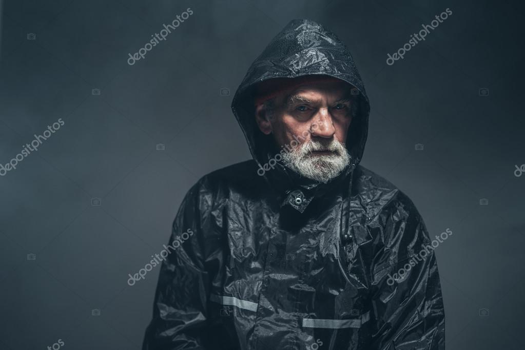 Humorless Old Man in Rain Jacket — Stock Photo © ysbrand 73639579