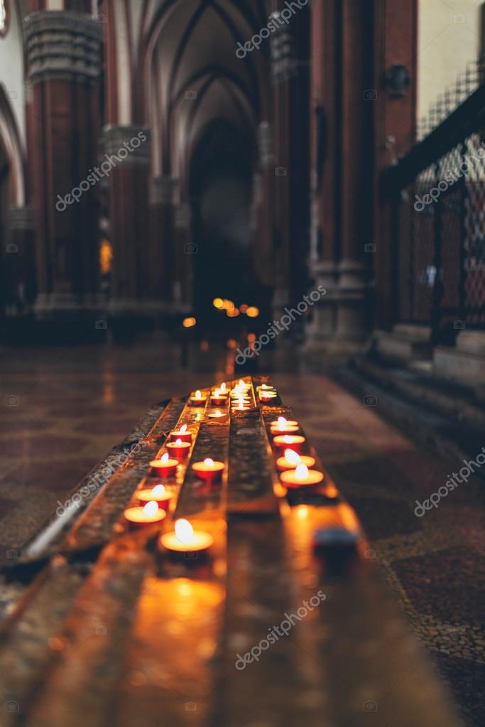 Rows of burning spiritual candles in a church ??? Stock Photo ?? ysbrand