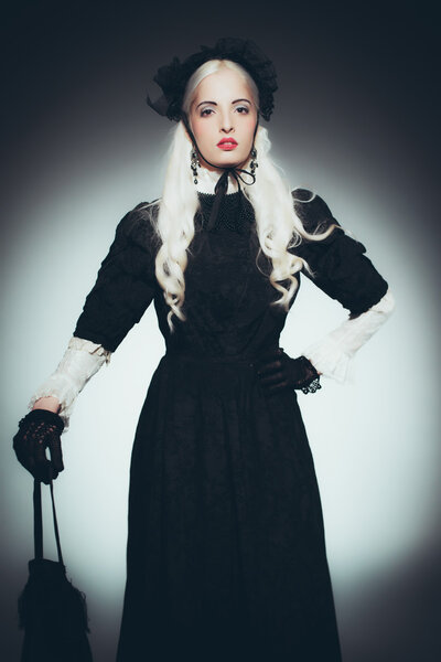 Woman with Hand Bag in Black Gown