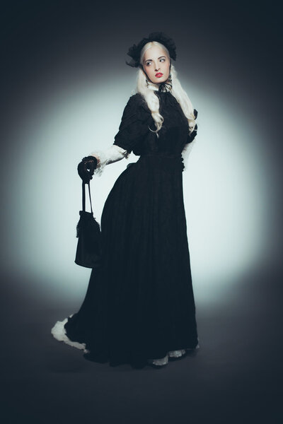 Woman with Hand Bag in Black Gown