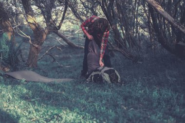 Backpacker unpacking his rucksack