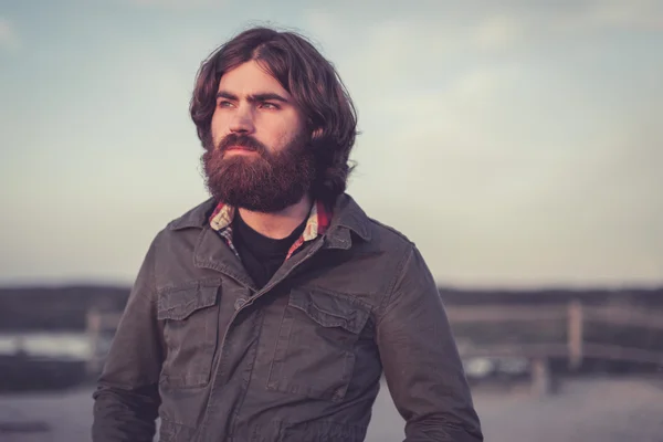 Handsome bearded man standing staring Stock Photo