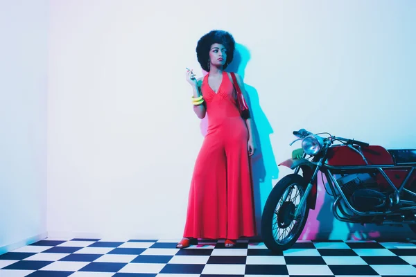 Stylish Lady Smoking Beside her Vintage Motorcycle — 图库照片