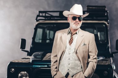 Man in Formal Fashion Against his Vehicle