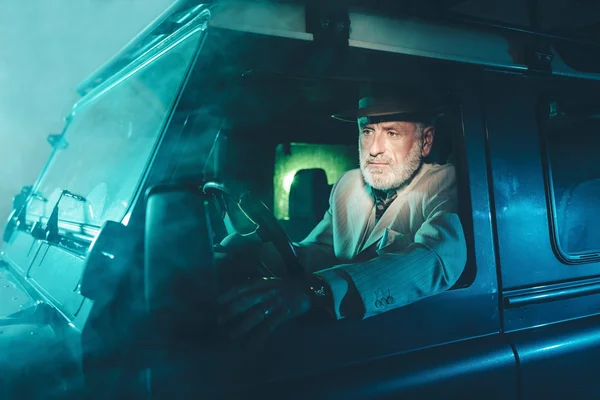 Senior Businessman Driving his Vehicle at Night — Stockfoto