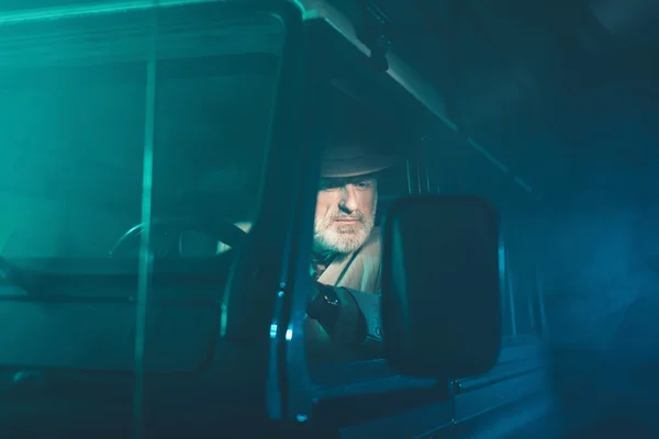 Senior Guy Looking at the Side Mirror — Stockfoto