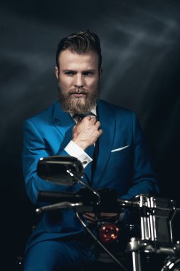 Handsome businessman on a motorbike