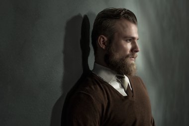 Thoughtful man standing daydreaming