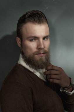Thoughtful worried bearded young man