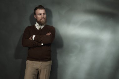 Confident man standing with folded arms