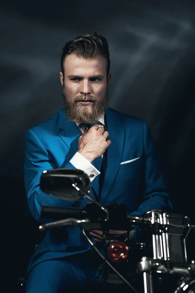 Handsome businessman on a motorbike — Stok fotoğraf