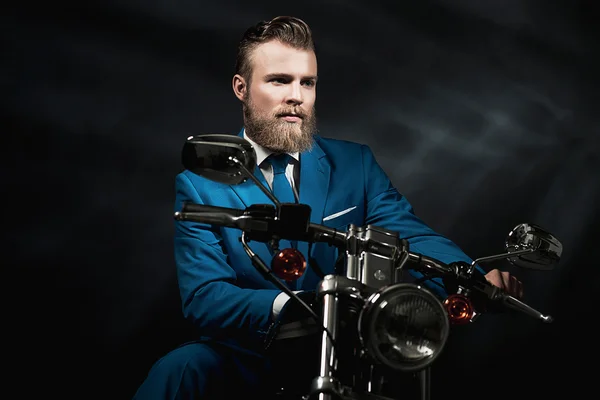 Handsome businessman on a motorbike — Stock Photo, Image