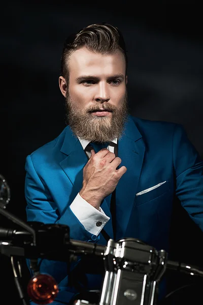 Handsome businessman on a motorbike — Stockfoto