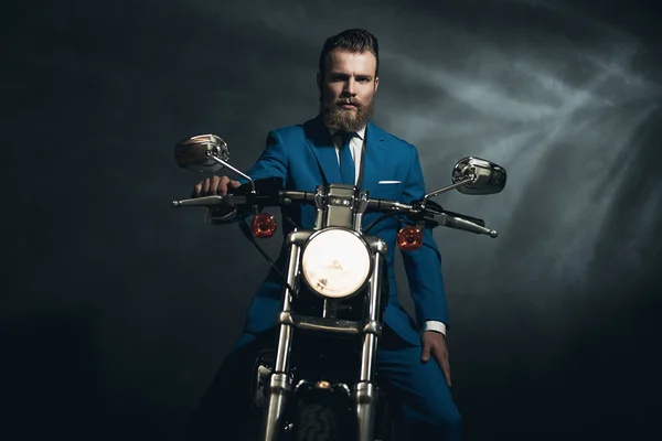 Handsome businessman on a motorbike — Stock Photo, Image