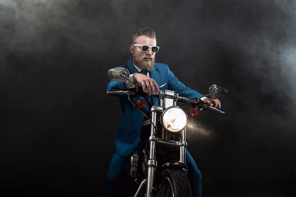 Trendy businessman on a motorbike — Stok fotoğraf