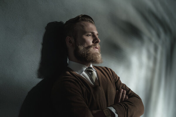 Thoughtful man standing daydreaming