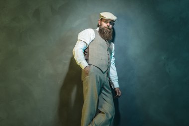 Thoughtful Bearded Man Leaning Against Wall