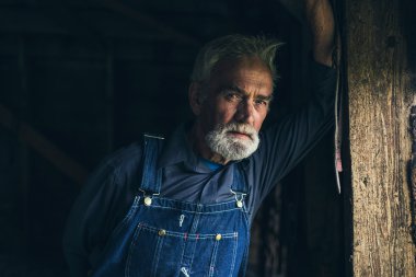 Elderly man staring through window