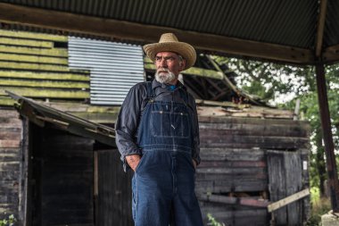 Farmer standing in front of rustic barn