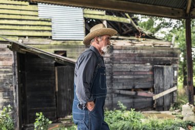 Farmer standing in front of rustic barn