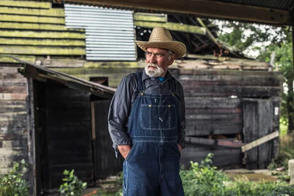 Farmer standing in front of rustic barn — Stock Photo, Image