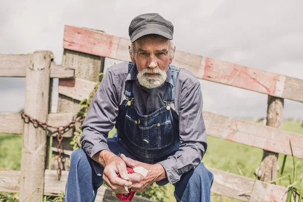 Elderly farm worker sitting relaxing