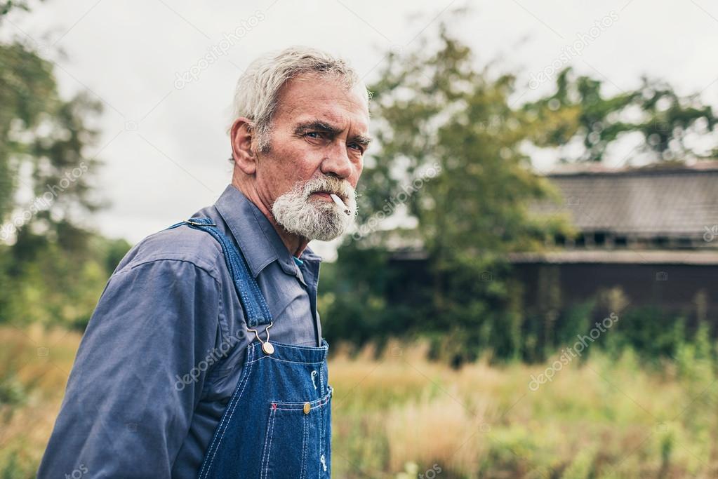 Pensive Senior Man Smoking Cigarette