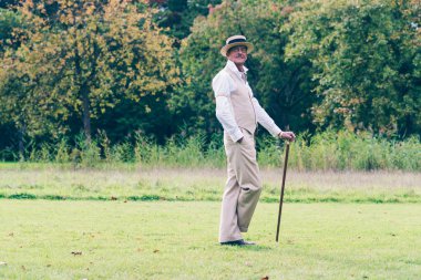 Dandy standing with cane
