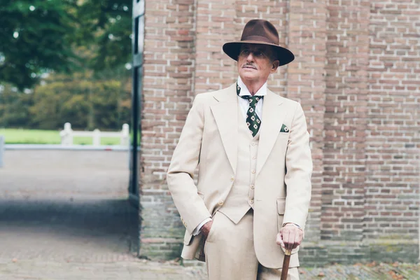 Senior dandy standing with cane — Stock Photo, Image