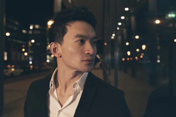 Asian businessman on street at night. — Stock Photo, Image