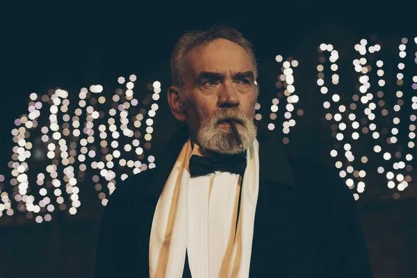 Cigar smoking man in tuxedo — Stock Photo, Image