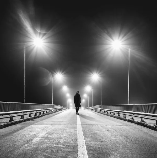 Sad lonely woman walking empty freeway at night — Stock Photo, Image