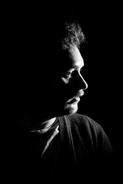 Young man's portrait. Close-up face against black background — Stock Photo, Image